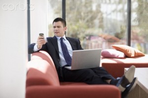 Businessman with laptop on sofa