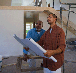 Construction workers inside unfinished house