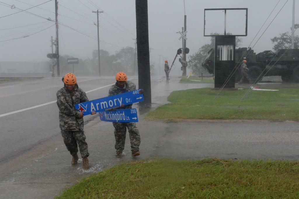 Texas Guardsmen from the 386th Engineer Battalion pick up large debris following Hurricane Harvey in Victoria, Texas, August 26, 2017. More than 1200 Texas Guardsmen partnered with Emergency first responders to support hurricane rescue missions throughout the Gulf Coastal areas of Texas. (U.S. Army National Guard photo by Capt. Martha Nigrelle)