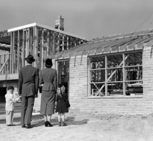 1950s Family Looking At New Home Under Construction