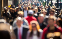 Anonymous crowd of people walking on New York City street sidewalk